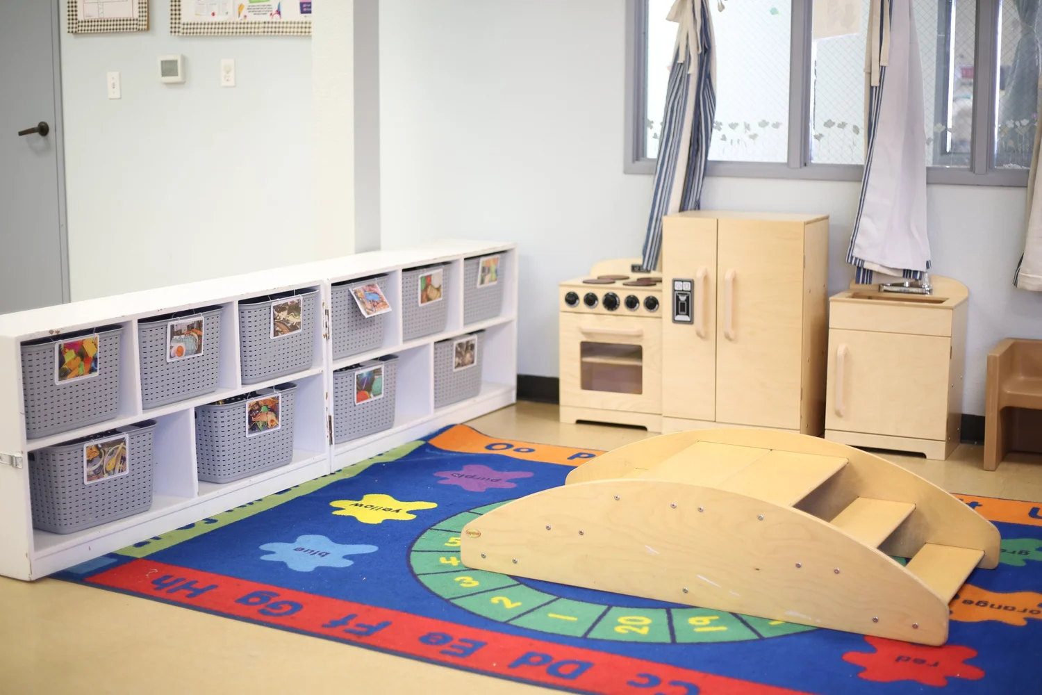 Golden Poppy classroom with learning materials and wooden play kitchen