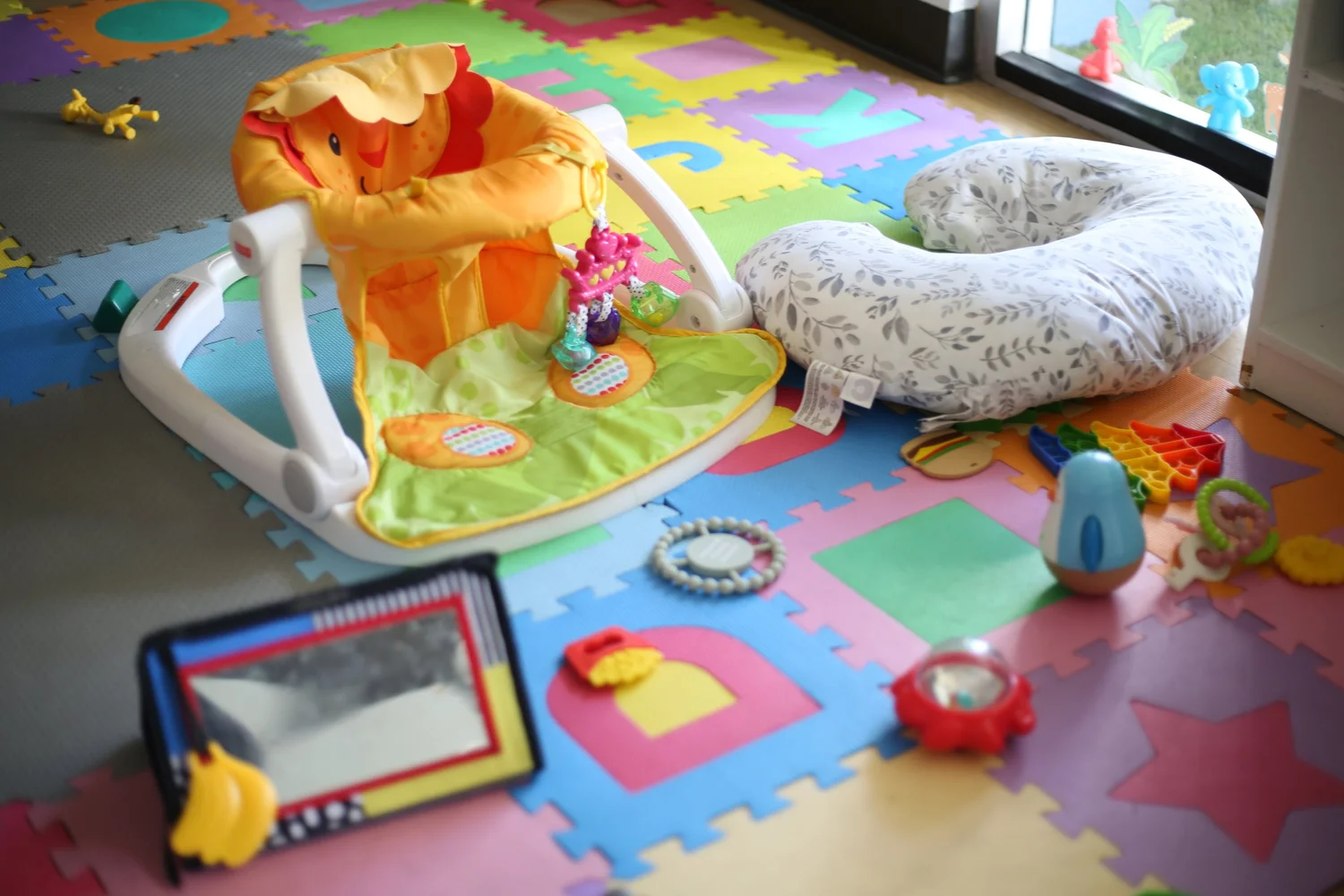Colorful soft mats and toys in the Golden Poppy infant classroom